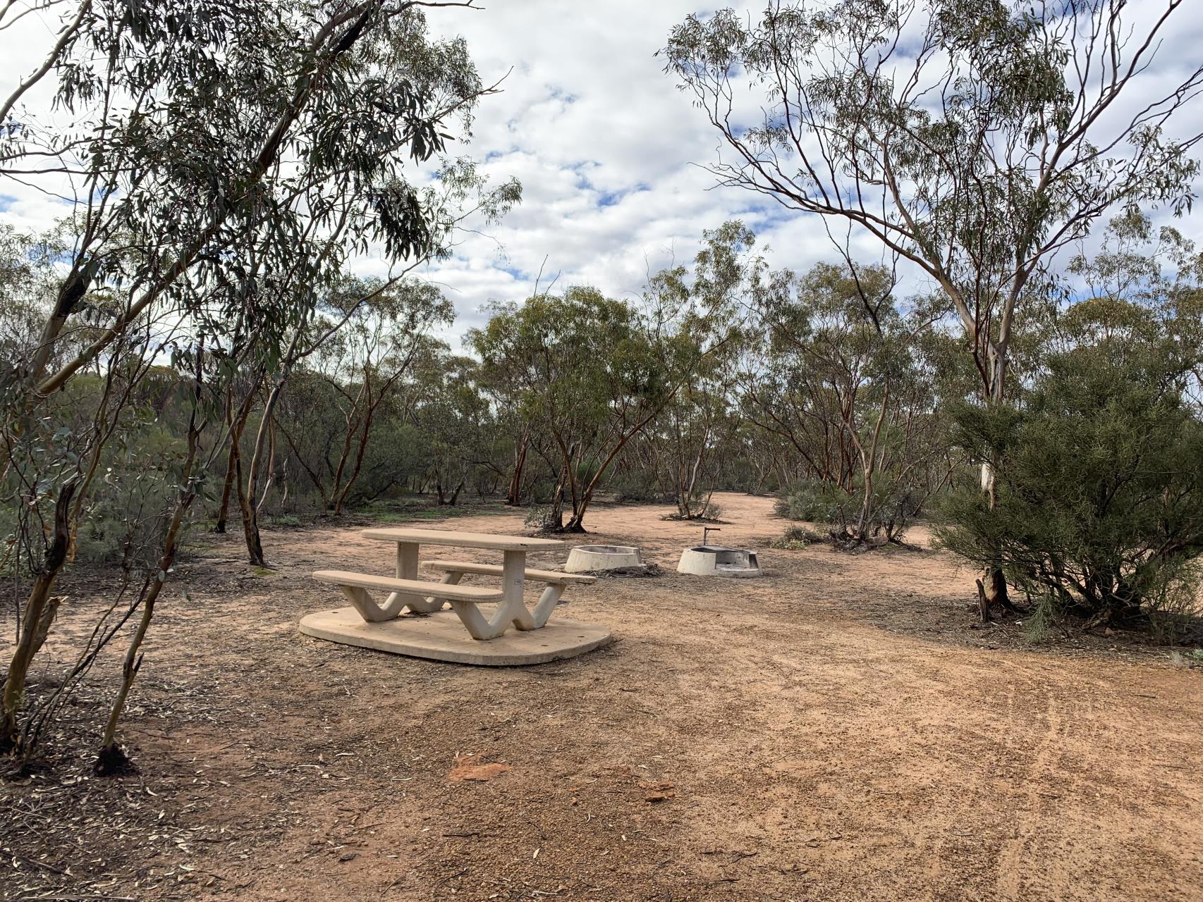 Wooden picnic tables set up as a rest stop along the trail